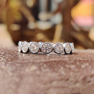 White gold milgrain wedding band with intricate details.