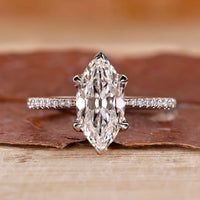 Marquise cut diamond ring with pave round cut band.