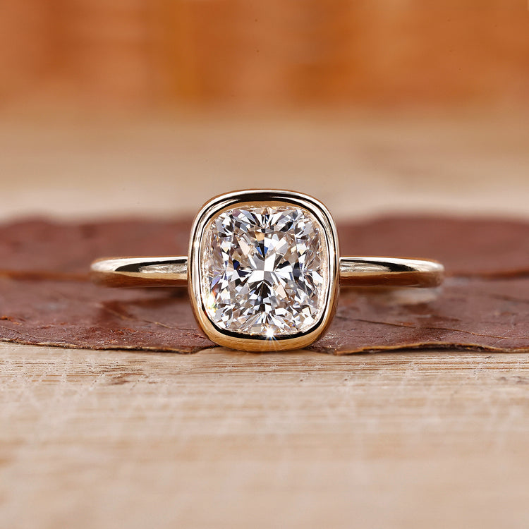 Bezel set engagement ring featuring a stunning cushion diamond ring.
