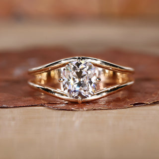 A stunning split shank diamond ring with a sparkling center stone.