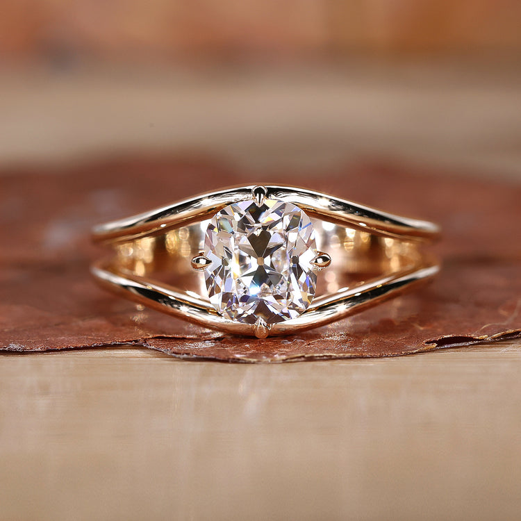A stunning split shank diamond ring with a sparkling center stone.