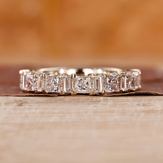 Yellow gold handmade band with princess and baguette stones.