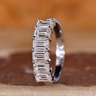 Emerald cut wedding band in shared prong setting.