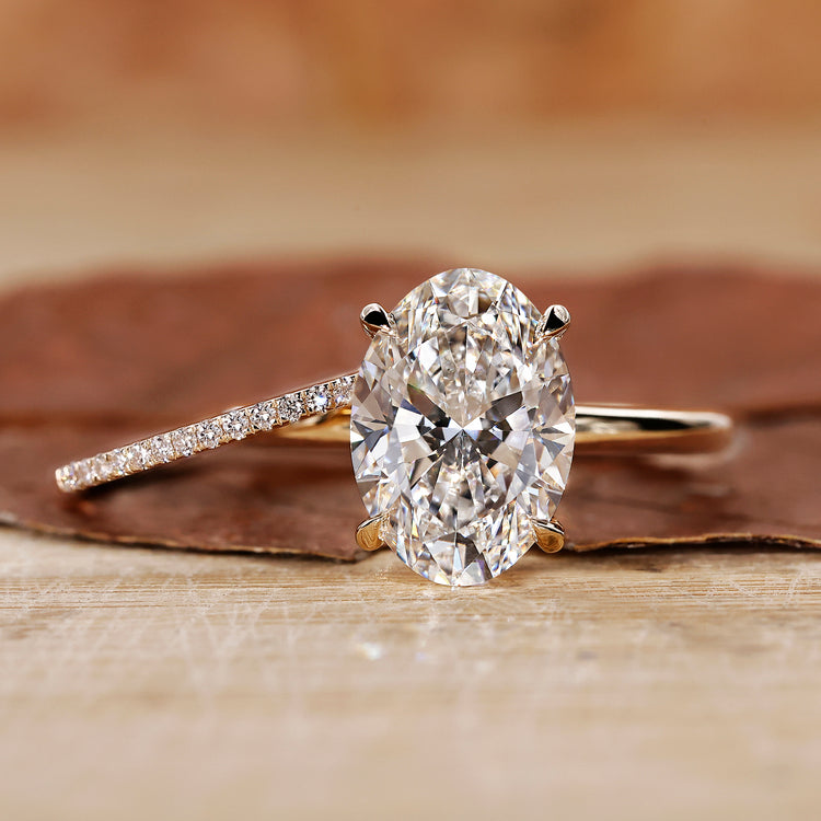 Oval Solitaire Engagement Ring with minimalist wedding band.