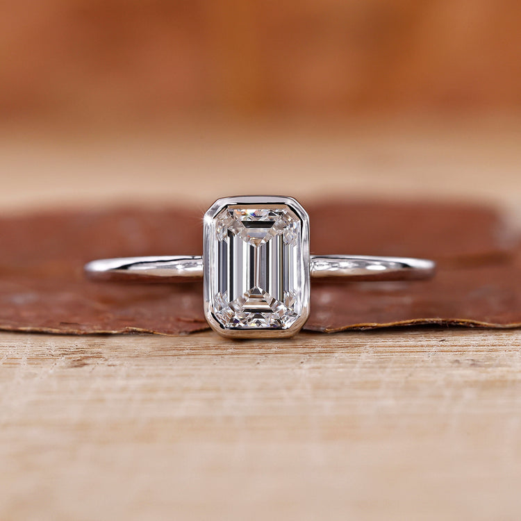 Solitaire Emerald Cut Ring featuring a stunning emerald cut diamond.