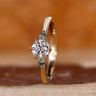 Round cut engagement ring with tapered shank ring design.