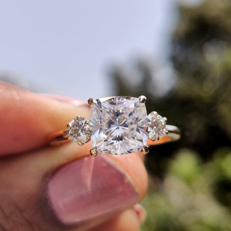 Three stone moissanite ring with a sparkling design.