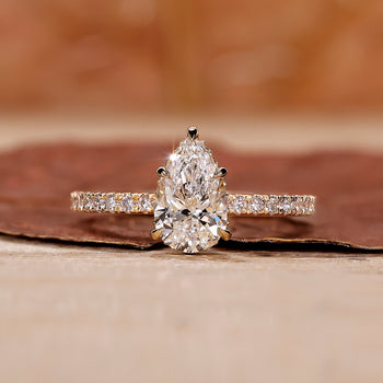 Pear shape diamond ring with a sparkling teardrop design and intricate details.