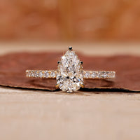 Pear shape diamond ring with a sparkling teardrop design and intricate details.