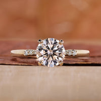 A stunning yellow gold engagement ring featuring a brilliant round diamond.