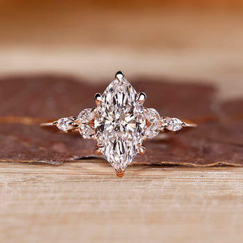 Marquise shaped diamond ring with muse setting and marquise side stone.