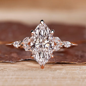 Marquise shaped diamond ring with muse setting and marquise side stone.