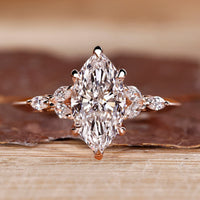 Marquise shaped diamond ring with muse setting and marquise side stone.