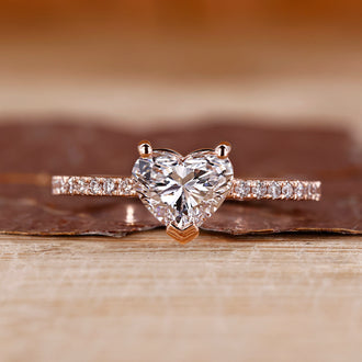 Heart shaped diamond ring in rose gold with pave setting design.