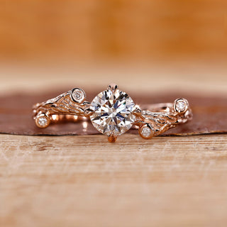 Nature-inspired engagement ring with intricate floral details and a stunning diamond center.