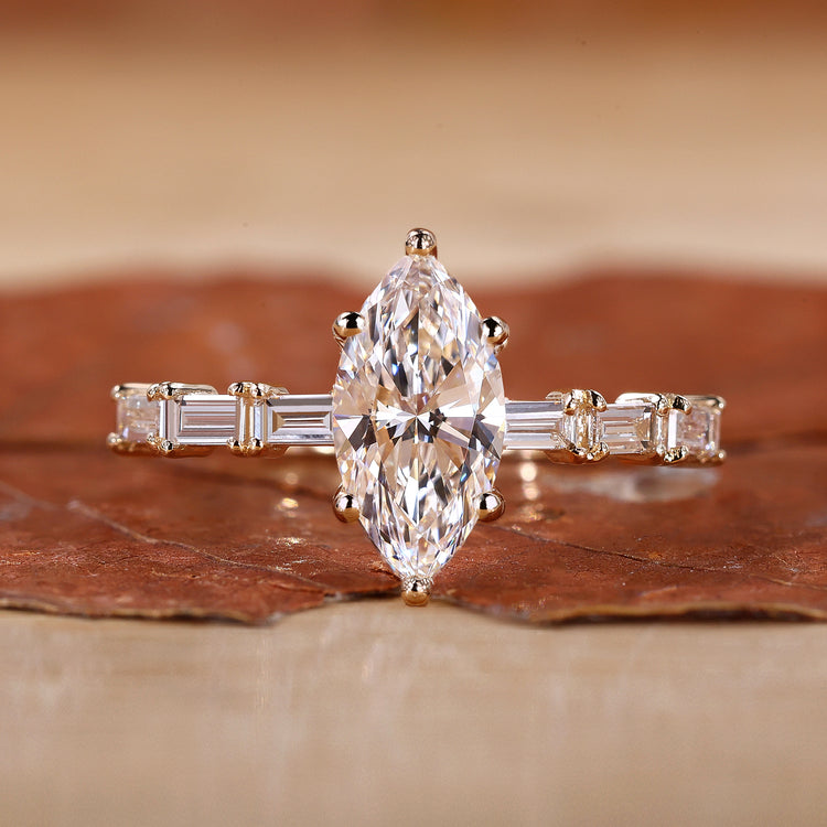 Gold Marquise engagement ring with dazzling baguette side stones.