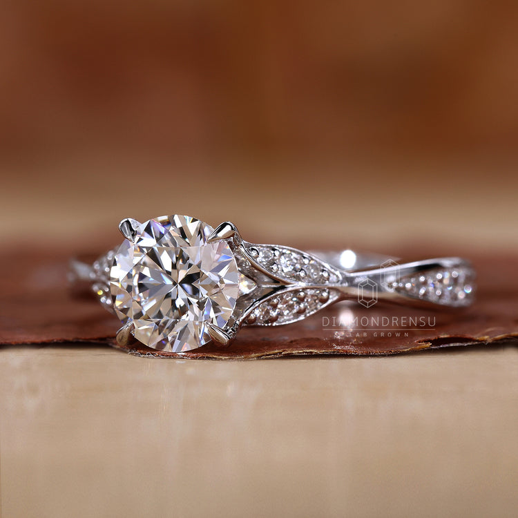 White gold ring featuring a nature-inspired wedding ring design with a round diamond and Wave Pave Band