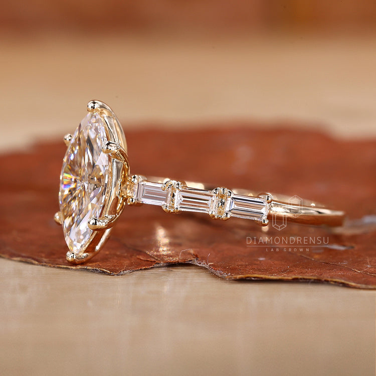 Yellow gold engagement ring with marquise centre and pave accents.