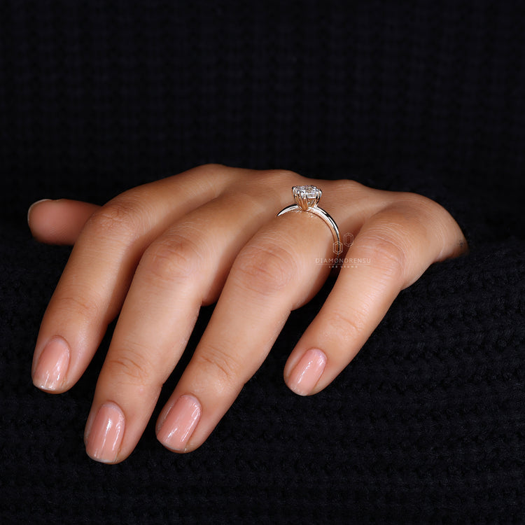 Gold solitaire engagement ring featuring a sleek modern style.
