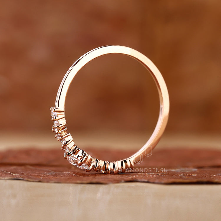 Rose gold engagement ring with delicate features.