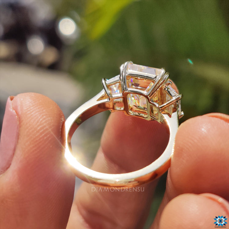 Handmade jewelry including a three stone engagement ring with moissanite.