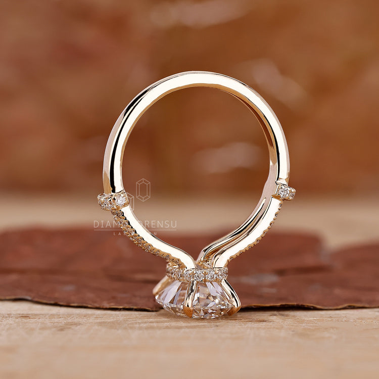 4 Prong Claw Setting on an oval hidden halo engagement ring.