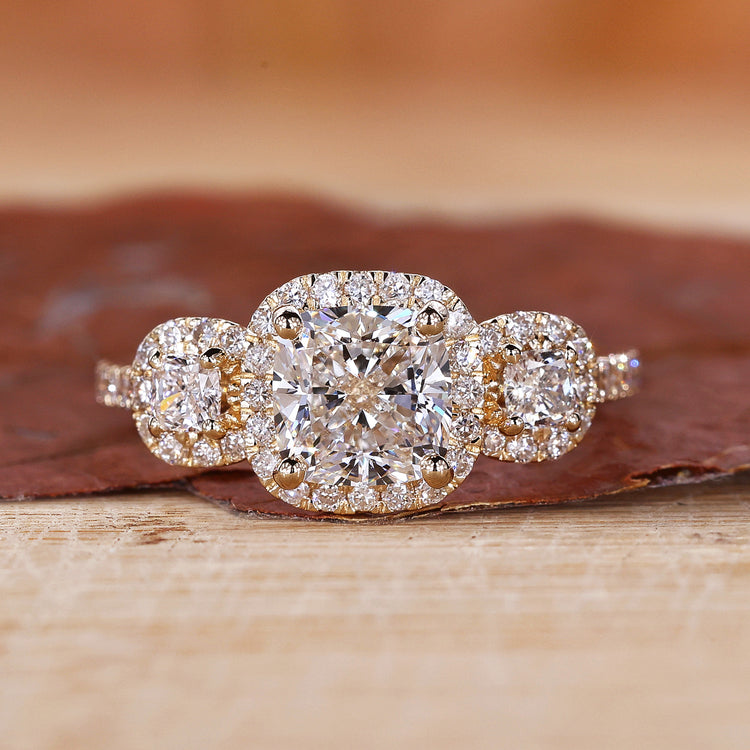 3 Stone Halo Engagement Ring with stunning cushion cut diamonds.