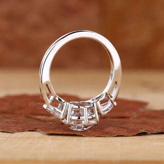 Three stone white gold ring with a sleek finish.