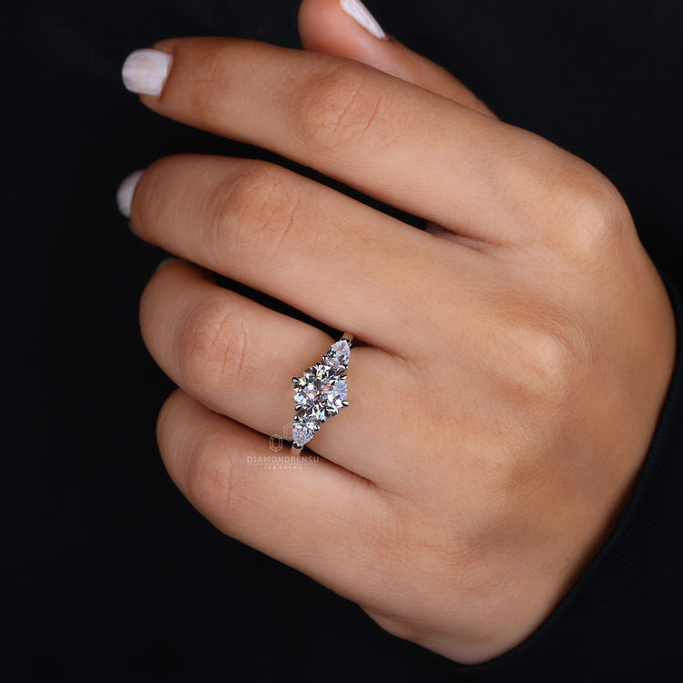 Beautiful three stone ring in modern design. Round diamond engagement ring set in classic elegance.