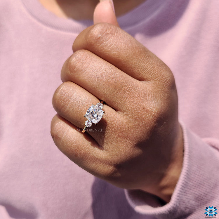 Round side stone ring featuring brilliant moissanite accents.