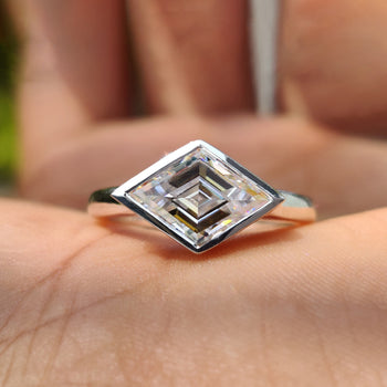 Lozenge cut engagement ring with a sleek solitaire setting.