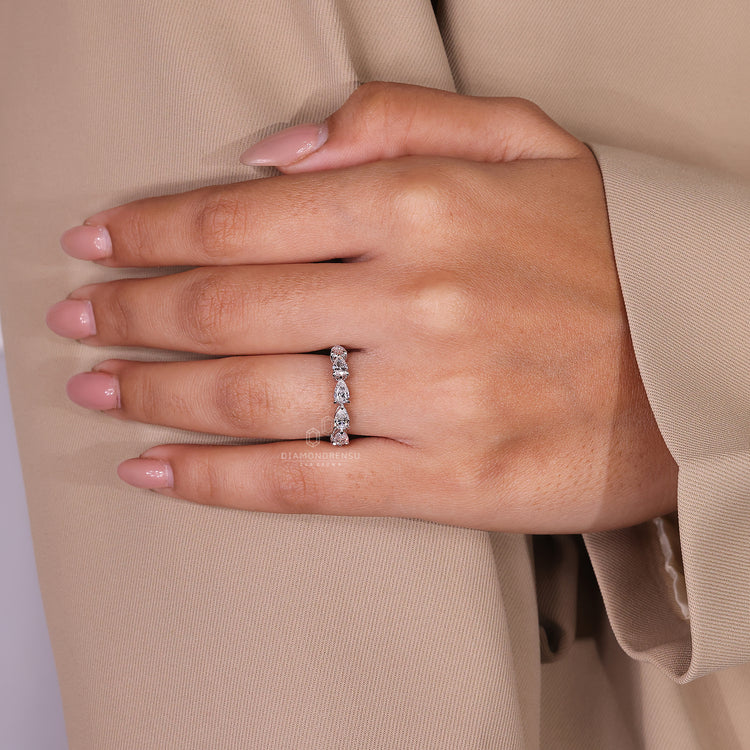 Handmade jewelry featuring a pear-shaped wedding band.