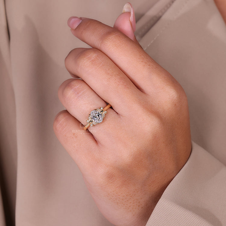 Round cut diamond ring with a beautiful oval diamond centerpiece for added elegance.