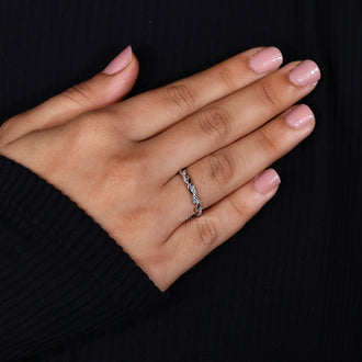 Lab grown diamond set in a modern twisted pave wedding band.