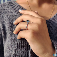 Solitaire setting moissanite ring with a bold blue hue.
