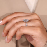 Radiant diamond center stone with round diamond side accents.
