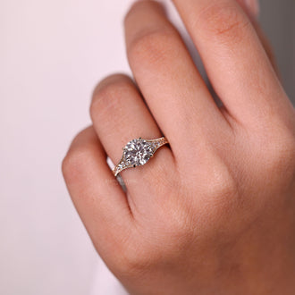 Bridge accent ring with round cut diamond.