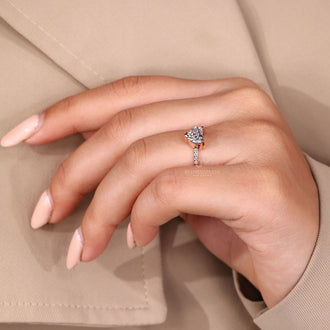 Custom diamond ring with heart shaped diamond and pave accents.