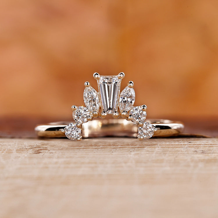 Crown wedding band with intricate design.