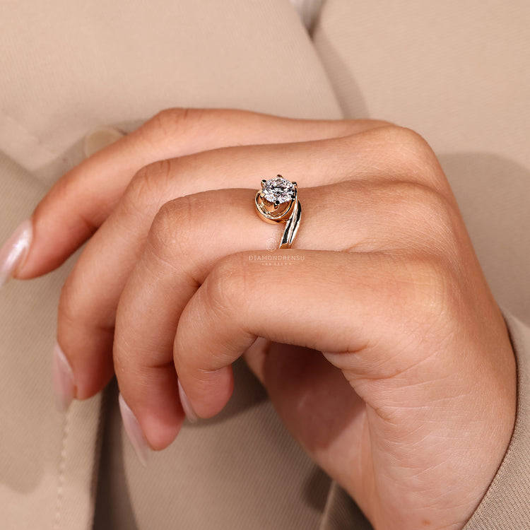 Round cut diamond ring with bypass ring setting.