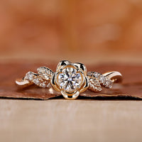 Handmade nature-inspired round diamond engagement ring with floral design and twisted pave band