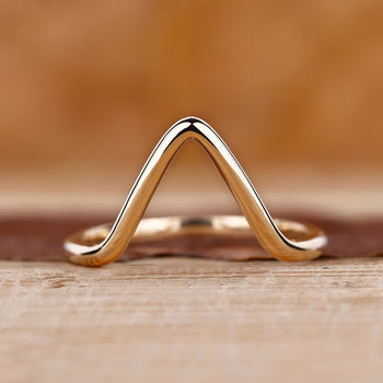 Gold chevron wedding band with a sleek design