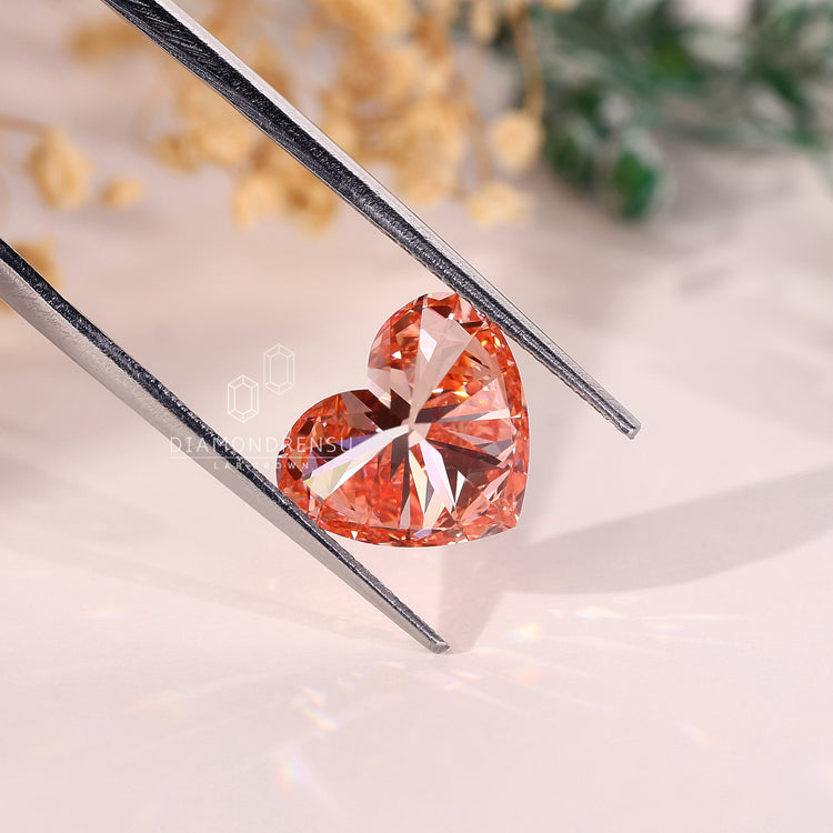 This lab grown pink diamond features a heart shape and comes IGI certified.