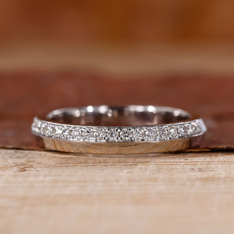 White gold wedding band with round diamond wedding band.