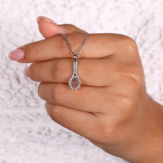 Round diamond pendant with prong set design in white gold.
