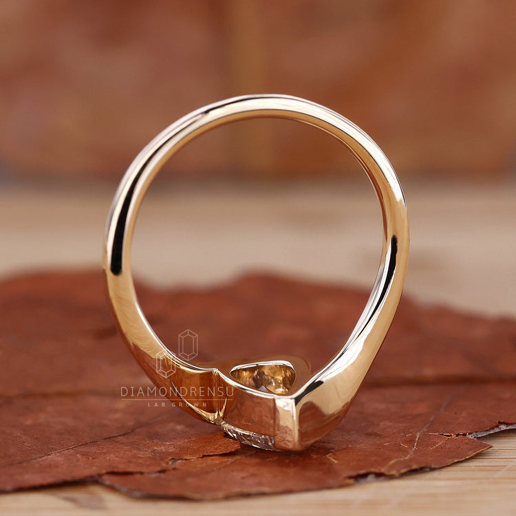 Handcrafted pear shaped engagement ring on modelβs hand