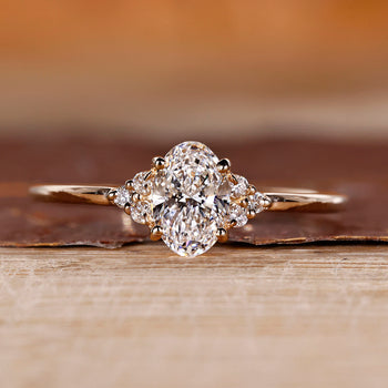 Oval diamond engagement ring in yellow gold with muse setting design.
