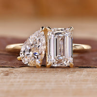 Toi et moi gold ring with pear and emerald cut diamonds.
