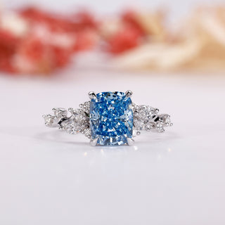 Blue diamond engagement ring with an elegant elongated cushion ring design.