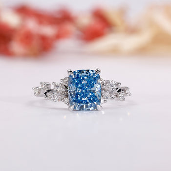 Blue diamond engagement ring with an elegant elongated cushion ring design.